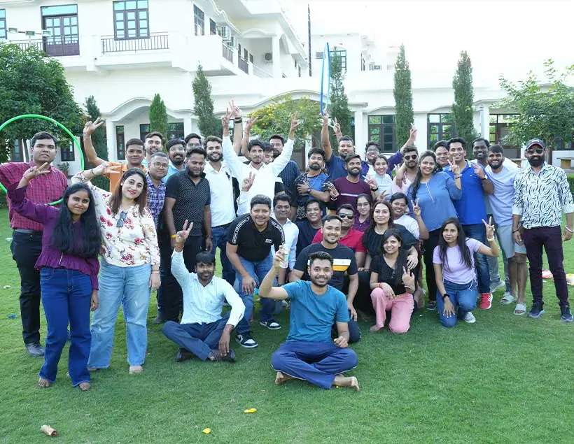 The offshore activation team gathered on a lawn outside a white building.